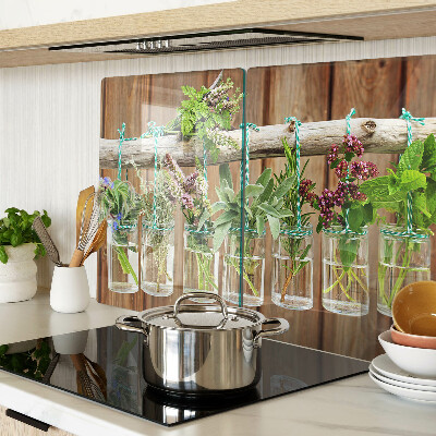 Glass chopping board Herbs in jars on a wooden background