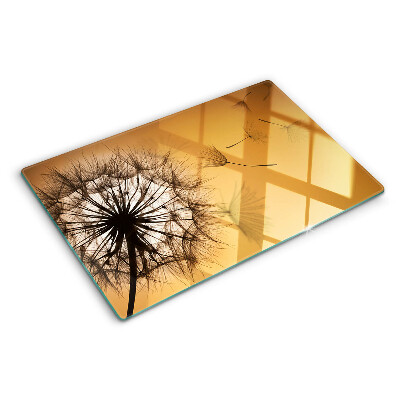 Glass chopping board Dandelions against the sunset background