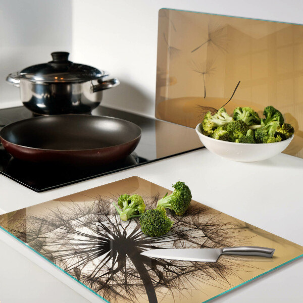 Glass chopping board Dandelions against the sunset background