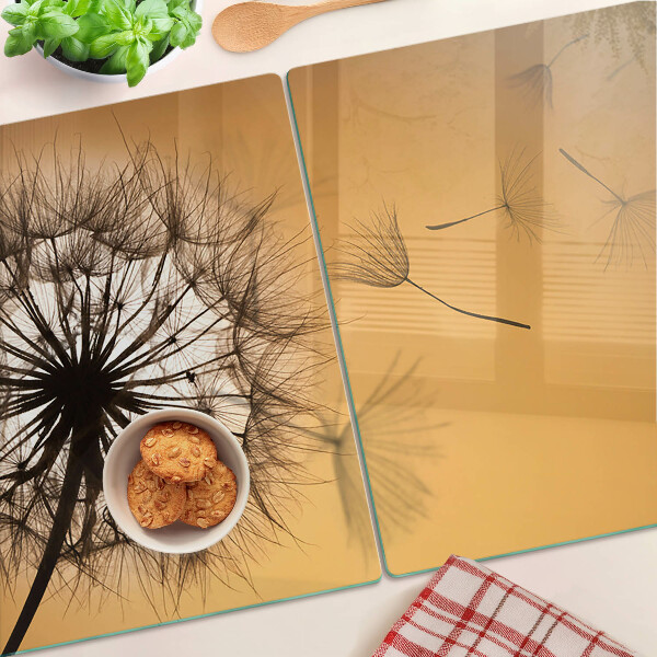 Glass chopping board Dandelions against the sunset background