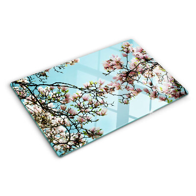 Glass cutting board Magnolia flowers on a blue background
