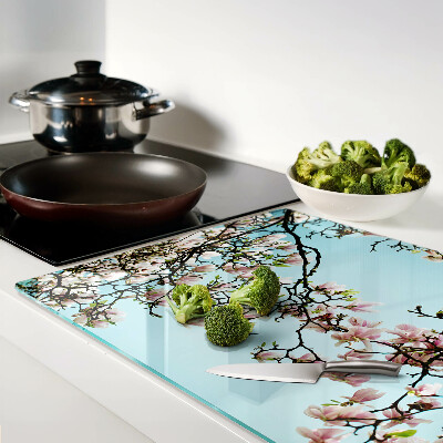 Glass cutting board Magnolia flowers on a blue background