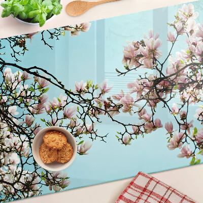 Glass cutting board Magnolia flowers on a blue background