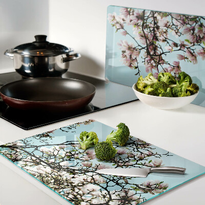 Glass cutting board Magnolia flowers on a blue background
