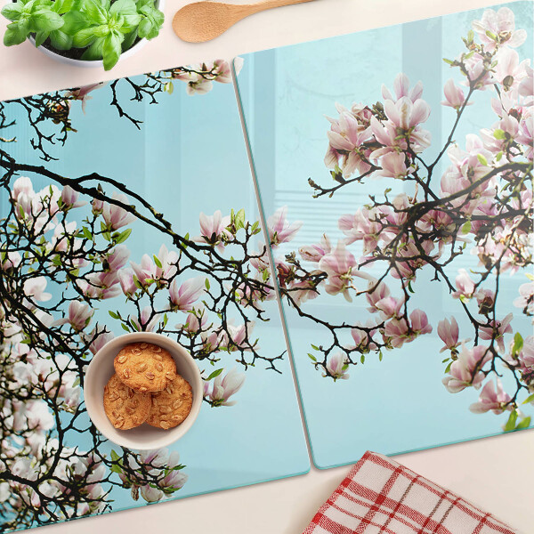 Glass cutting board Magnolia flowers on a blue background