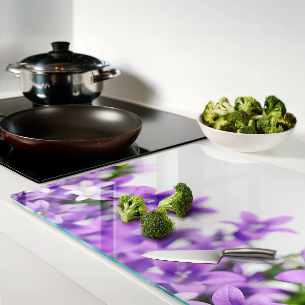 Glass cutting board Purple flowers in the background