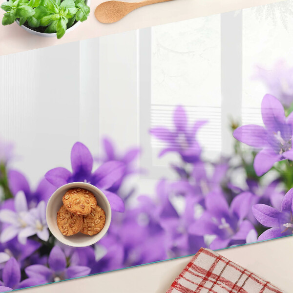 Glass cutting board Purple flowers in the background
