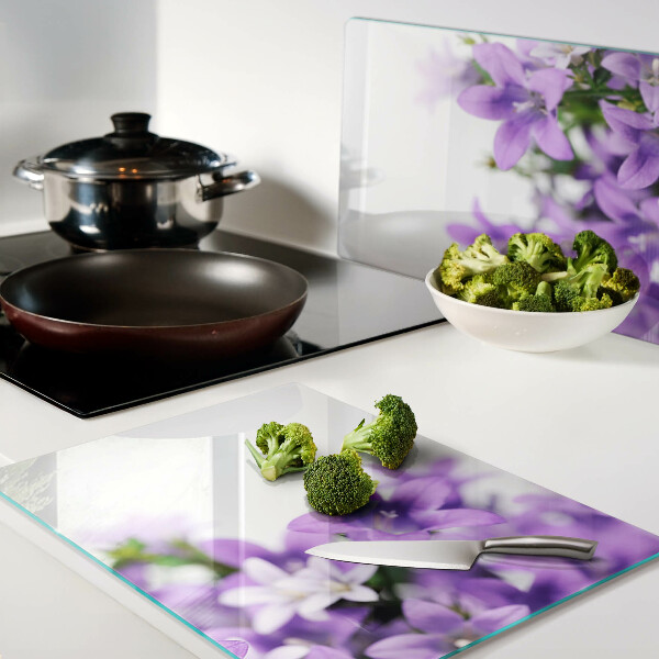 Glass cutting board Purple flowers in the background