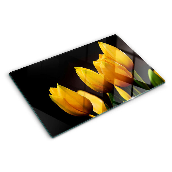 Glass kitchen board Yellow tulips on a black background