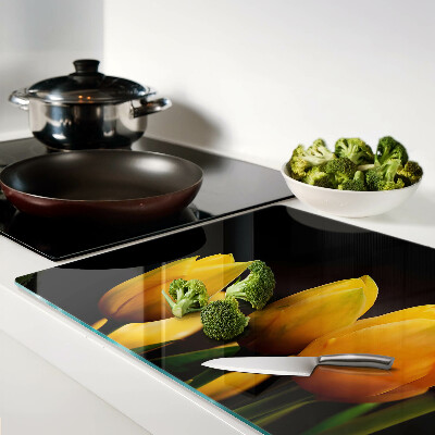Glass kitchen board Yellow tulips on a black background