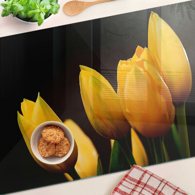 Glass kitchen board Yellow tulips on a black background