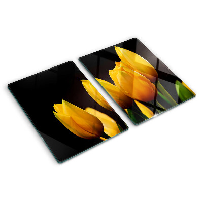 Glass kitchen board Yellow tulips on a black background