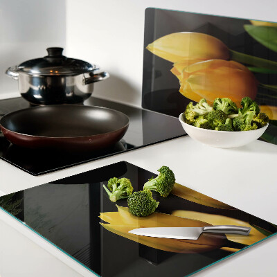 Glass kitchen board Yellow tulips on a black background