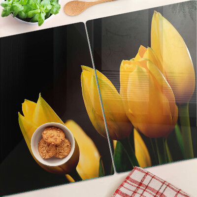 Glass kitchen board Yellow tulips on a black background