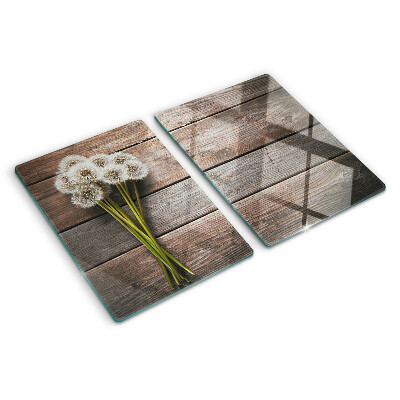 Glass chopping board Dandelion flowers on a wooden background