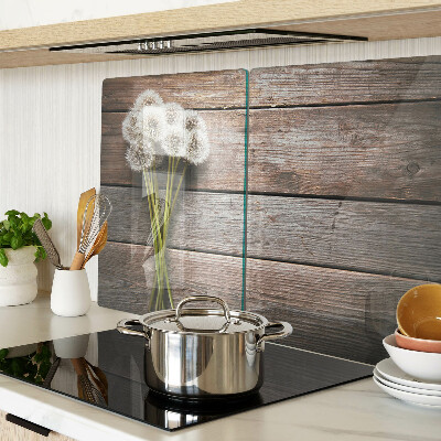 Glass chopping board Dandelion flowers on a wooden background