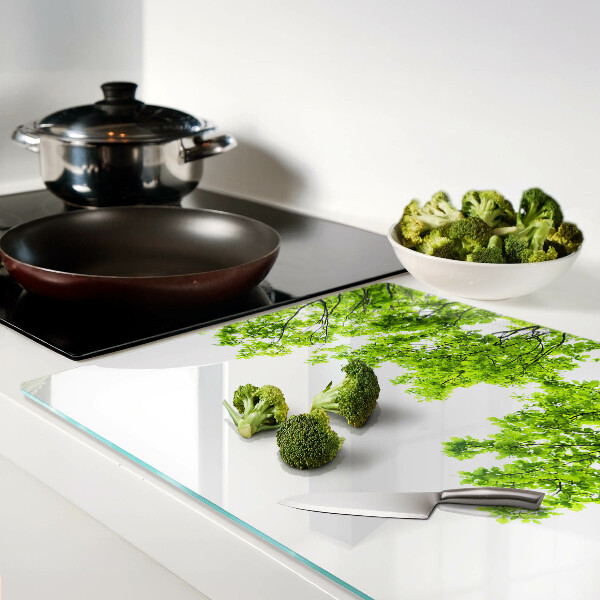 Glass kitchen board Green leaves against the sky