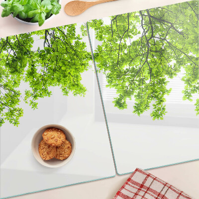 Glass kitchen board Green leaves against the sky