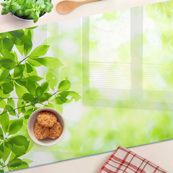Chopping board glass Green leaves in the light