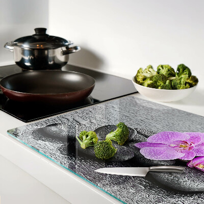 Cutting board Flowers and stones against the water background