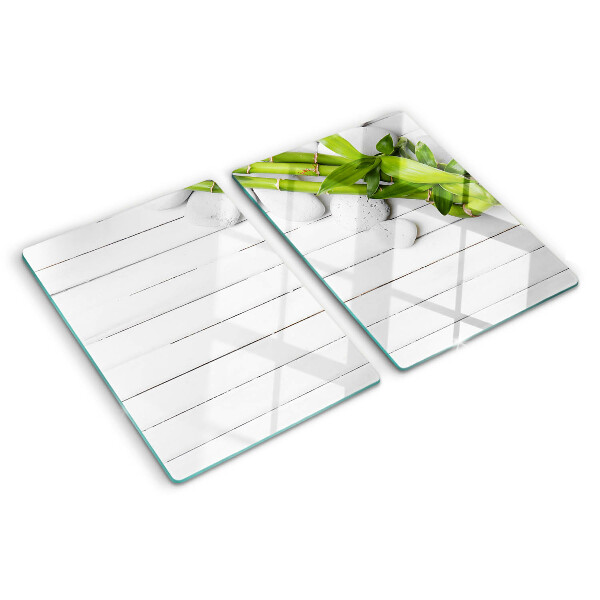 Glass chopping board Bamboo and stones on a wood background