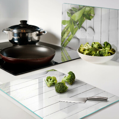 Glass chopping board Bamboo and stones on a wood background