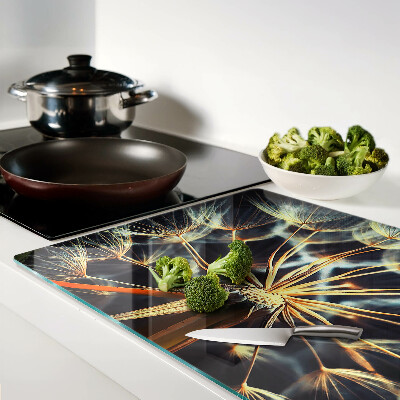 Chopping board glass Dandelions in macro photography