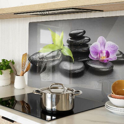 Glass chopping board Stones and orchid on the background