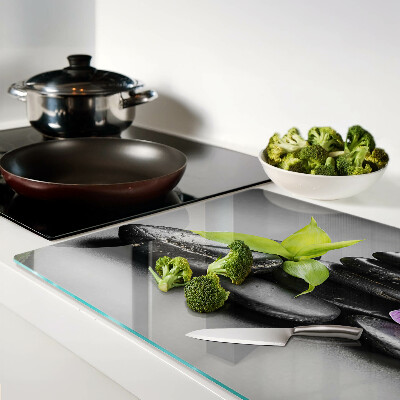 Glass chopping board Stones and orchid on the background