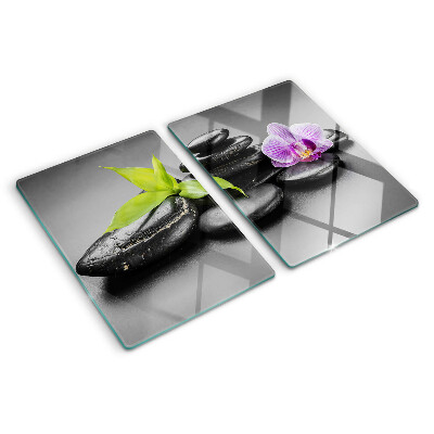 Glass chopping board Stones and orchid on the background
