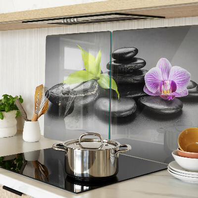 Glass chopping board Stones and orchid on the background