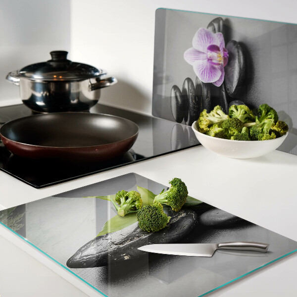 Glass chopping board Stones and orchid on the background