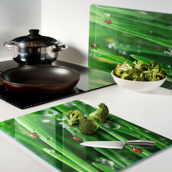Glass chopping board Water drops on grass with ladybugs