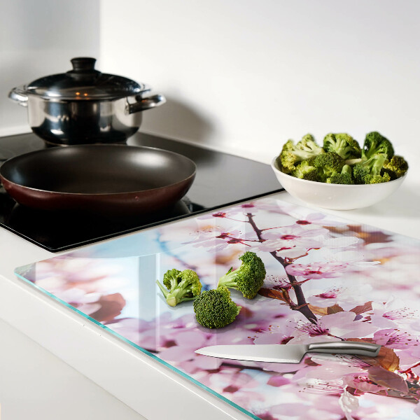 Glass chopping board Cherry blossoms on a blue background