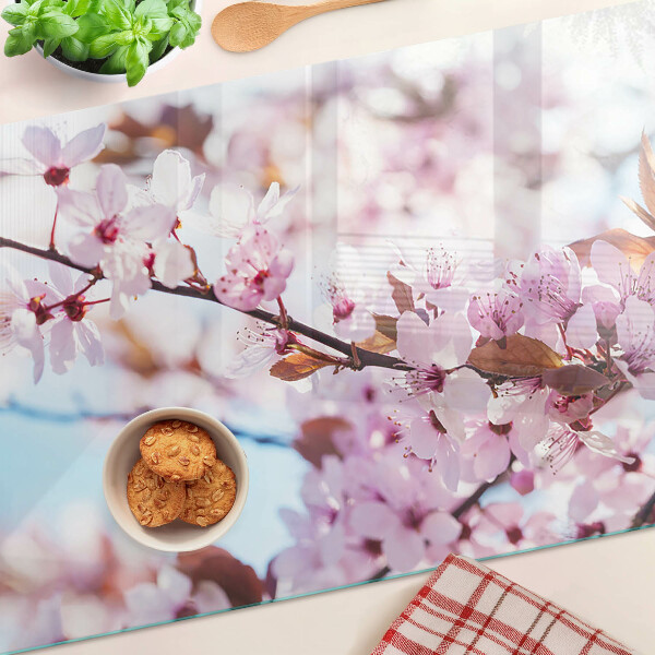 Glass chopping board Cherry blossoms on a blue background