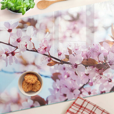 Glass chopping board Cherry blossoms on a blue background