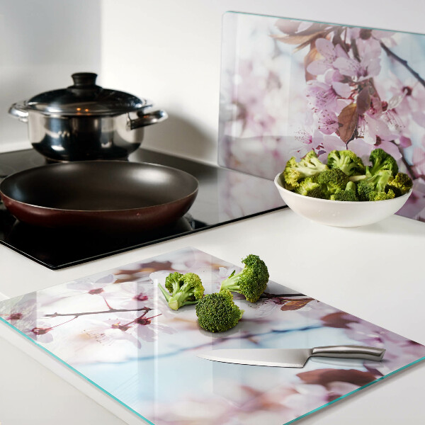 Glass chopping board Cherry blossoms on a blue background