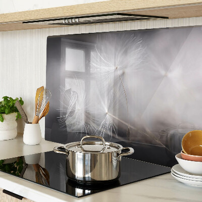 Glass chopping board Fluffy dandelions against the window background