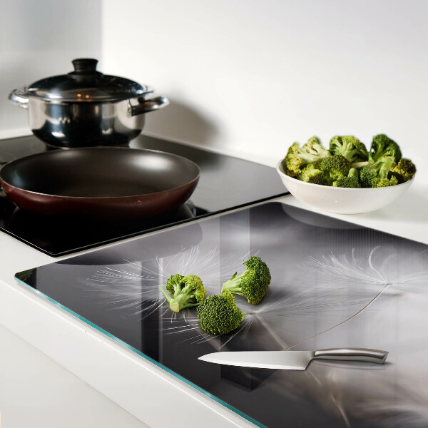 Glass chopping board Fluffy dandelions against the window background
