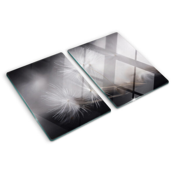 Glass chopping board Fluffy dandelions against the window background