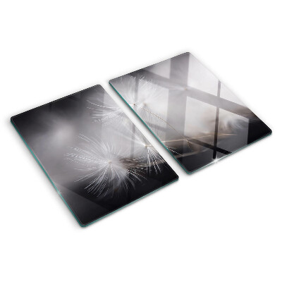 Glass chopping board Fluffy dandelions against the window background