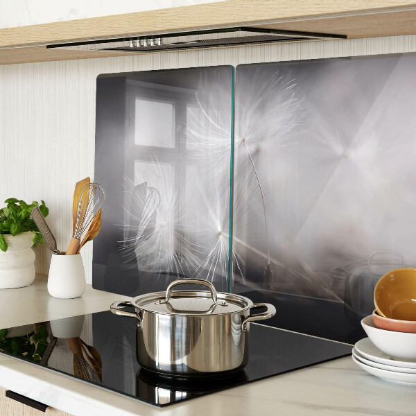 Glass chopping board Fluffy dandelions against the window background