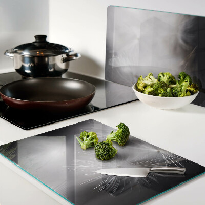 Glass chopping board Fluffy dandelions against the window background