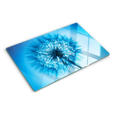 Chopping board glass Dandelion on a blue background