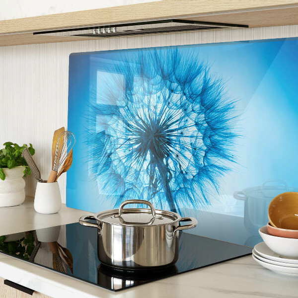 Chopping board glass Dandelion on a blue background