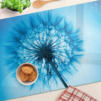 Chopping board glass Dandelion on a blue background