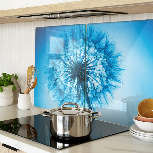 Chopping board glass Dandelion on a blue background