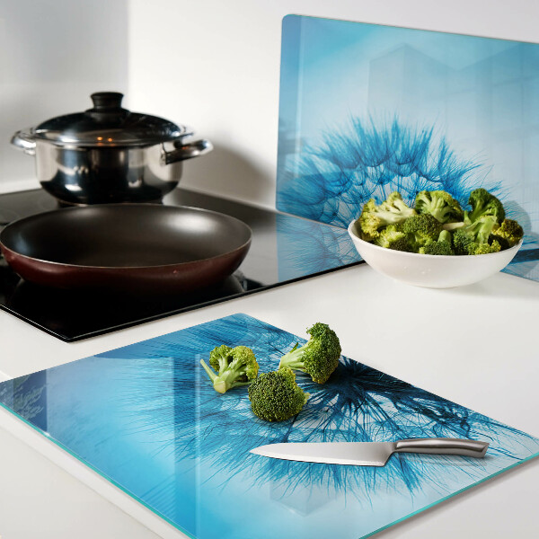 Chopping board glass Dandelion on a blue background