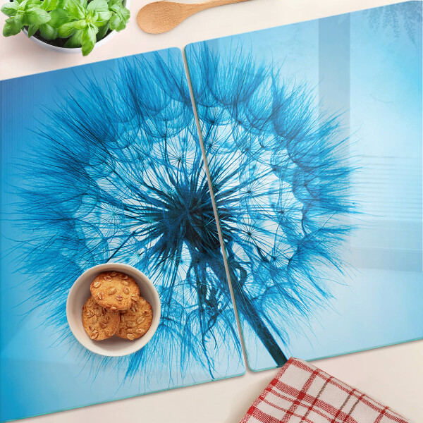 Chopping board glass Dandelion on a blue background