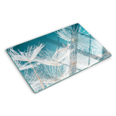 Chopping board glass Dandelions on a blue background